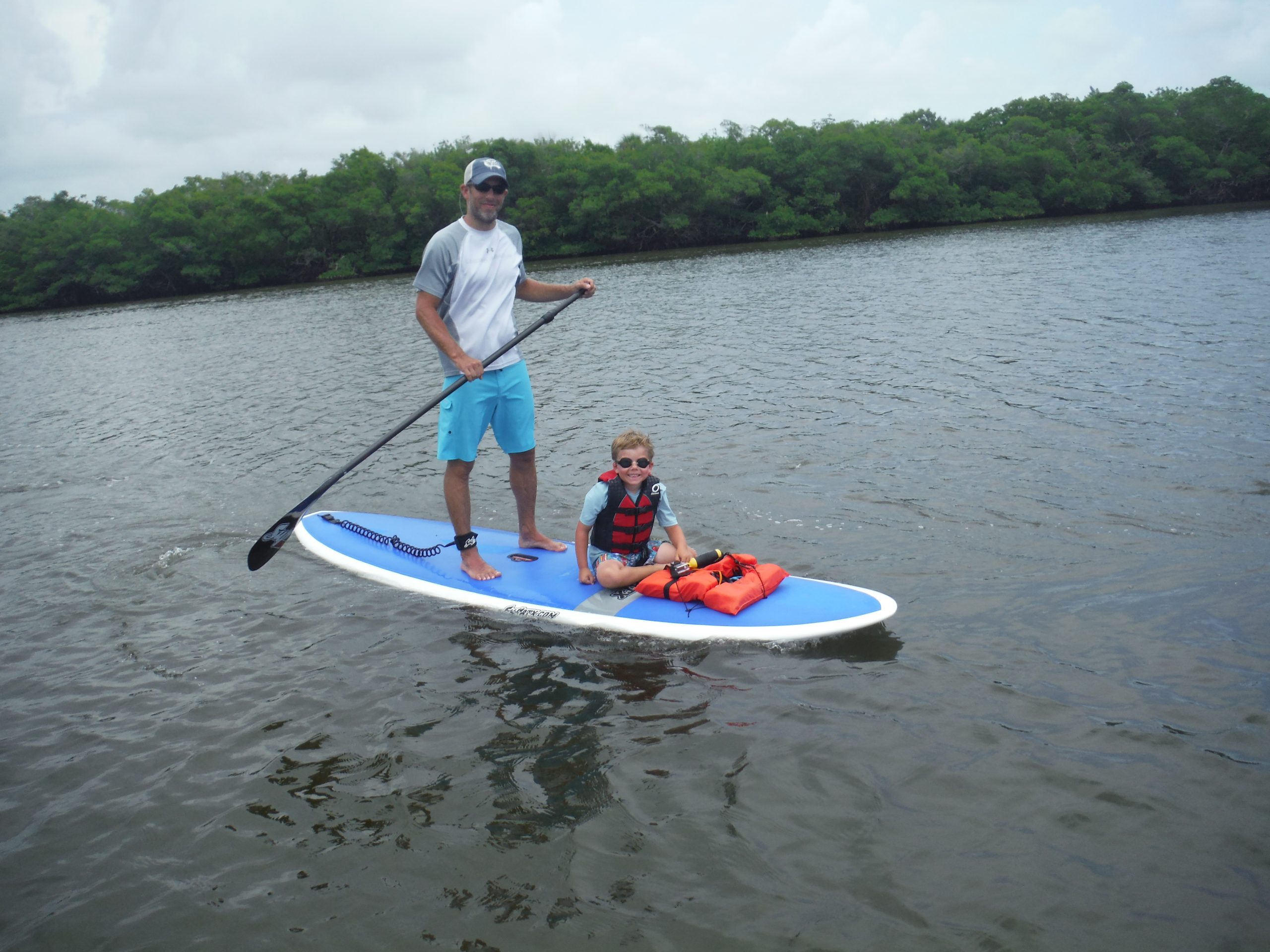 Child riding in front of paddle board